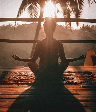 Person meditating peacefully outdoors representing personal growth